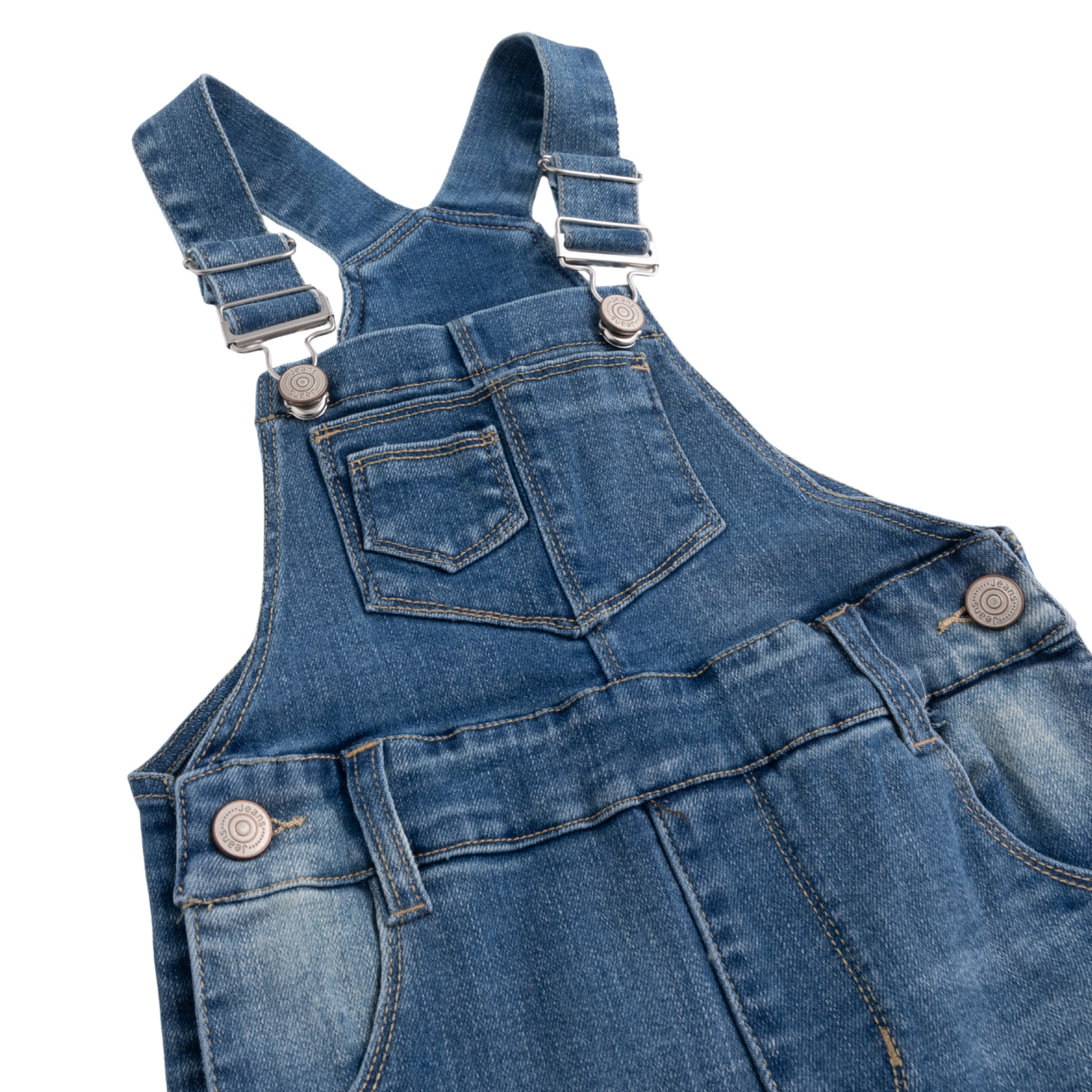 Close-up of a blue denim overall with adjustable shoulder straps, metal snap buttons, front patch pocket, and reinforced seams on a white background.