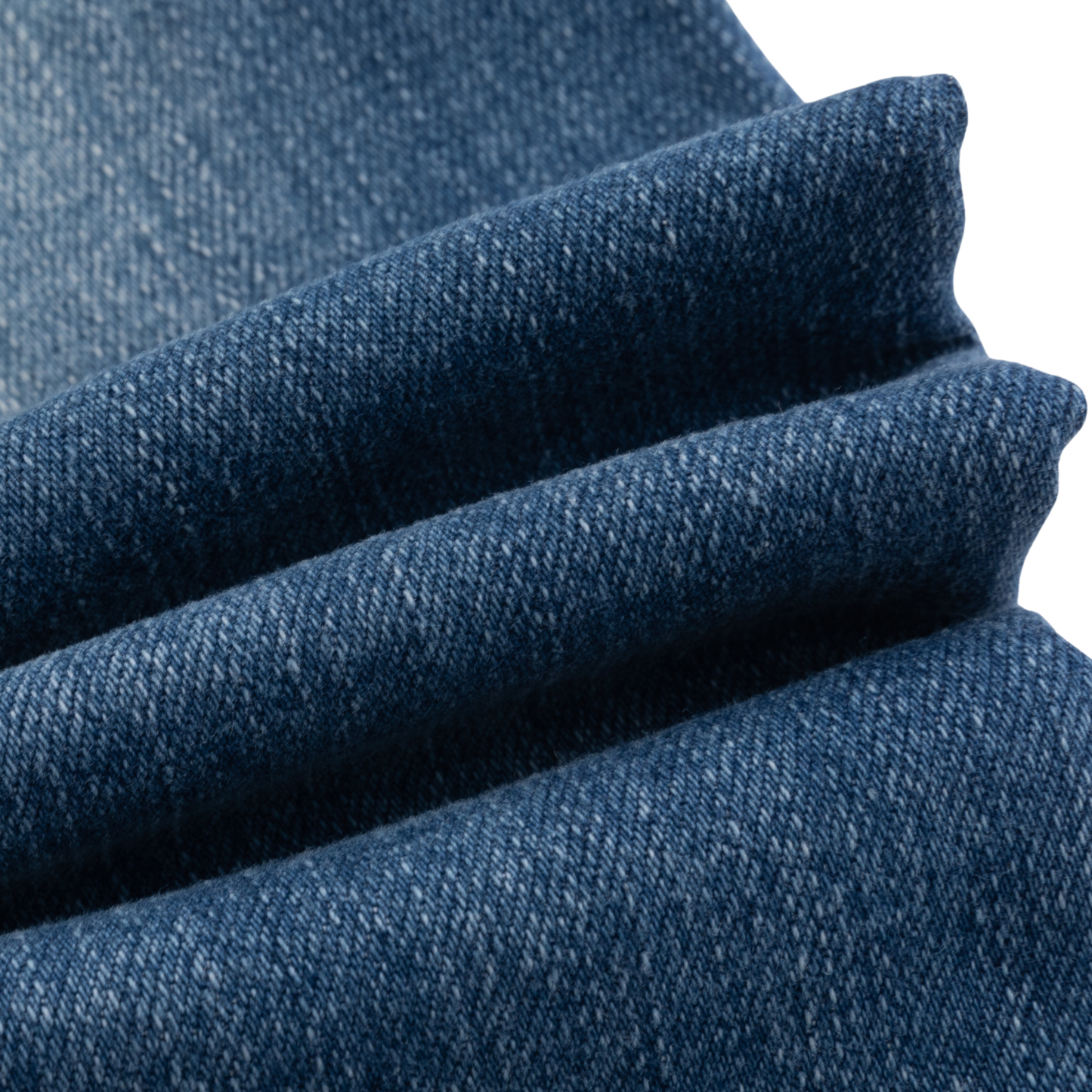A close-up of folded blue denim fabric showing the detailed twill weave texture against a white background.